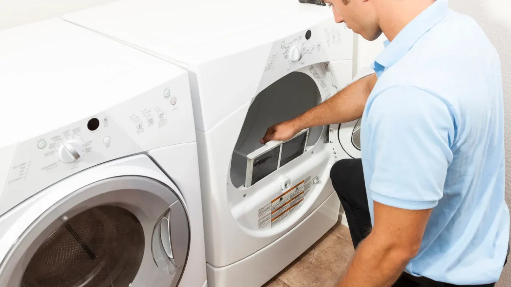Person reaching toward a dryer lint-filter opening