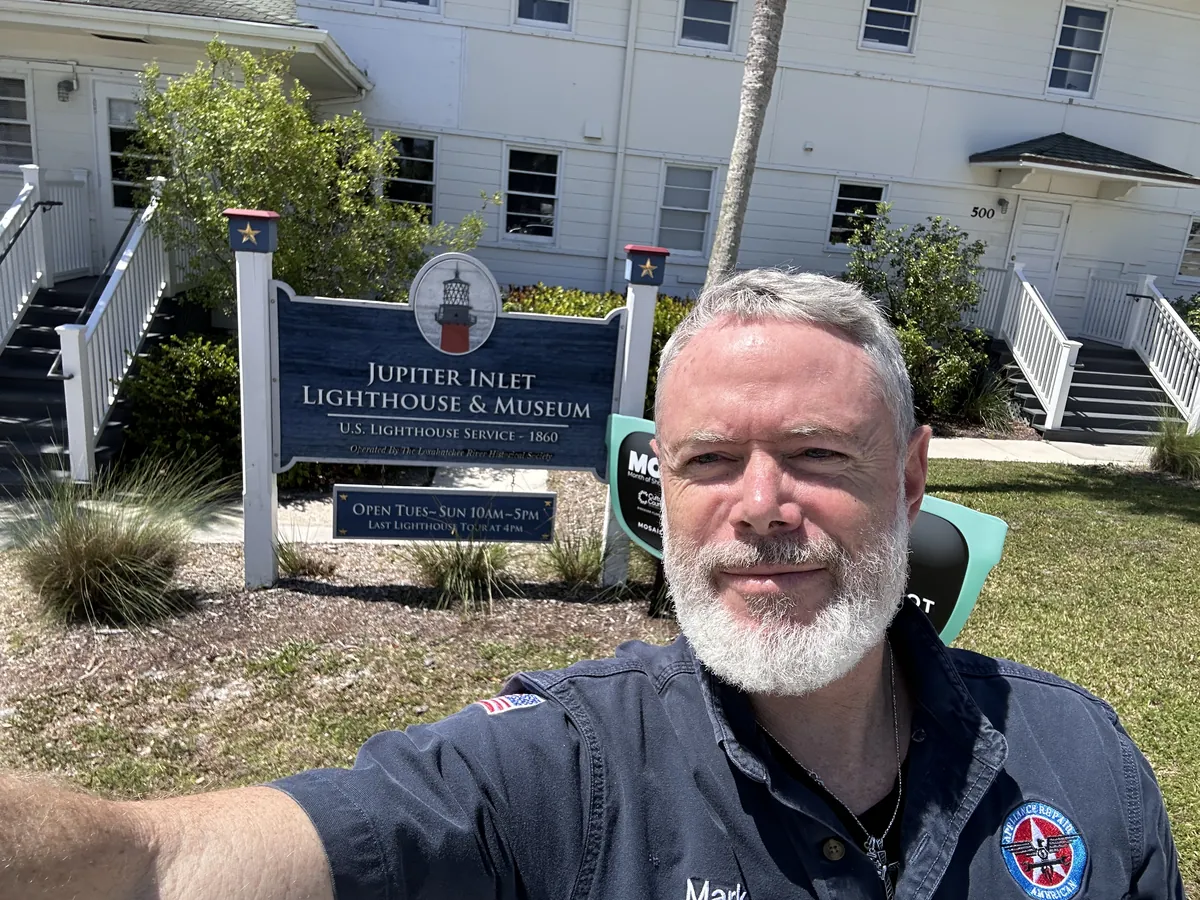 Mark Oliver of Appliance Repair American beside the Jupiter Inlet Lighthouse and Museum sign.